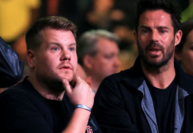 Television personality James Corden, left, and footballer turned broadcaster Jamie Redknapp watch from ringside