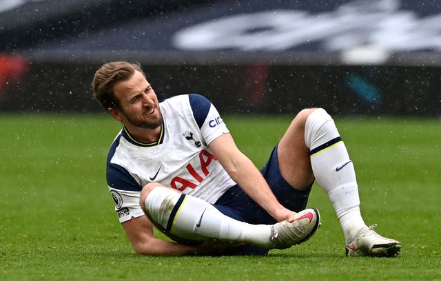 Harry Kane winces after taking another blow to his troublesome ankle against West Brom