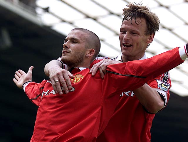 David Beckham (L) celebrates his winning goal against Tottenham