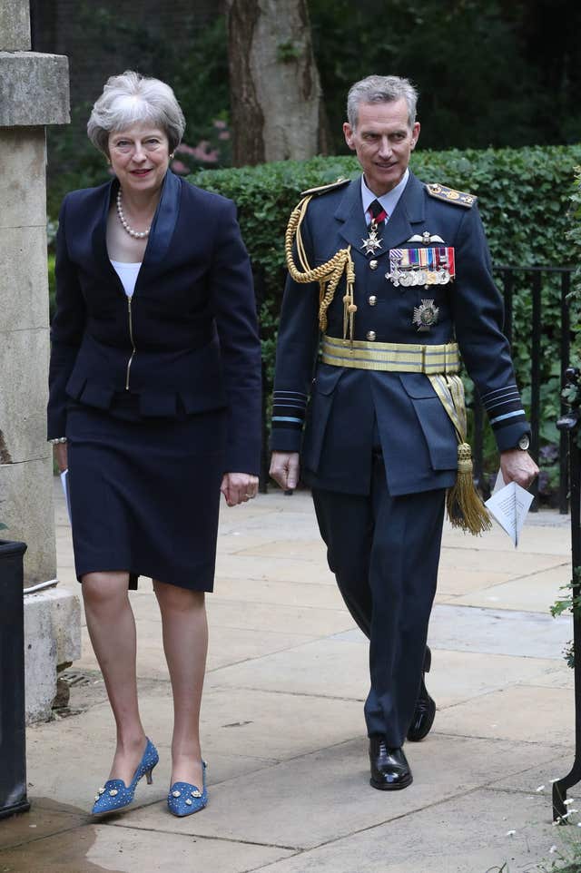 Prime Minister Theresa May walks with Air Chief Marshal Sir Stephen Hillier (Jonathan Brady/PA)
