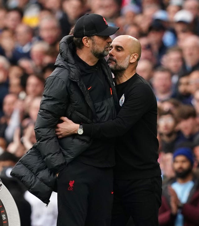 Manchester City manager Pep Guardiola embraces Liverpool manager Jurgen Klopp