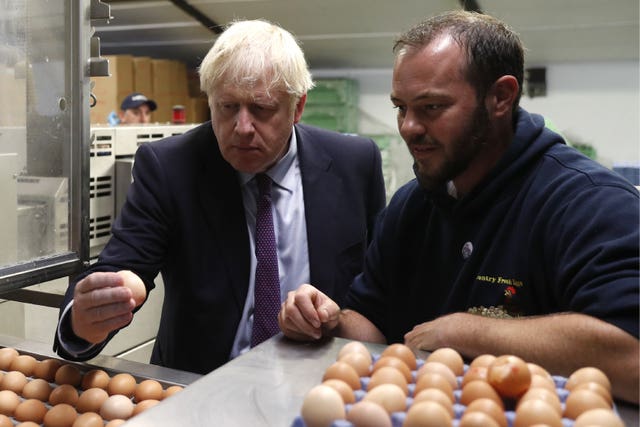 Boris Johnson inspects the egg operation with local farmer Matt Shervington-Jones
