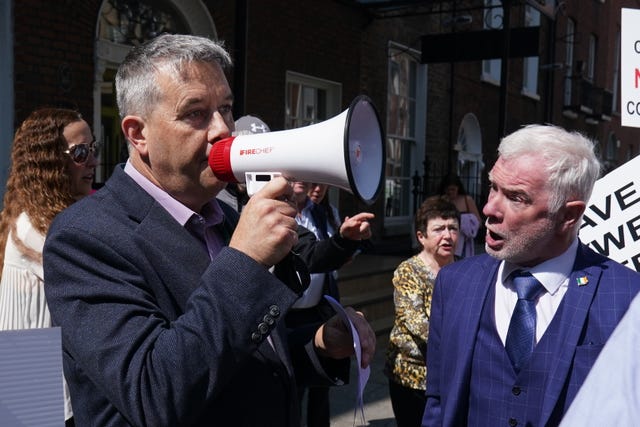Paul Gogarty (left) speaking to protesters with Dublin councillor Malachy Steenson (right) as people demonstrate