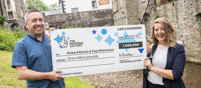Welsh couple holding first winning Lottery cheque