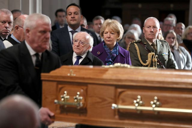 Irish President Michael D Higgins, his wife Sabina and Taoiseach Leo Varadkar watch as the coffin of the celebrated broadcaster Gay Byrne, is carried into St Mary’s Pro-Cathedral in Dublin