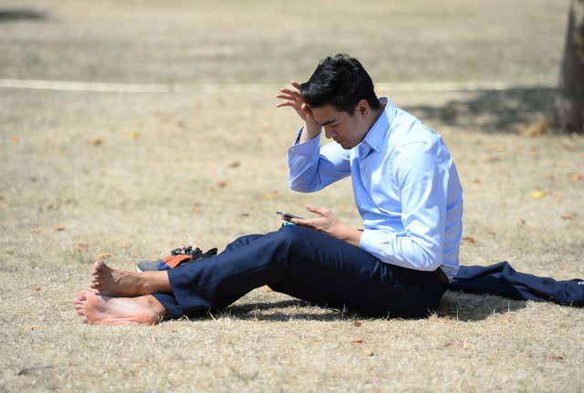 A man sitting on dry grass