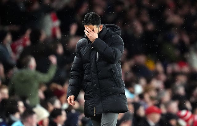 Ruben Amorim puts his left hand over his face in disappointment