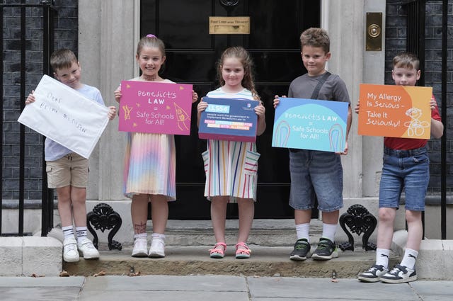 Five children, including Etta Blythe (third left), holding placards at the front of 10 Downing Street