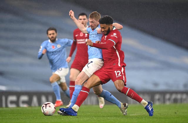Manchester City's Kevin De Bruyne and Liverpool's Joe Gomez battle for the ball