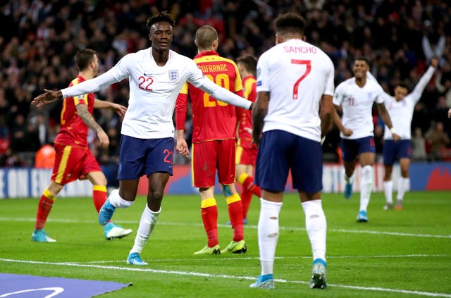 Twenty-two-year-old Tammy Abraham celebrates his first England goal with Jadon Sancho, 19