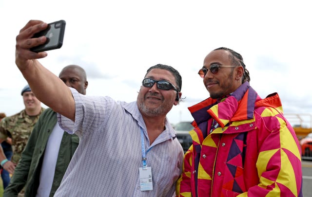 Hamilton poses with a fan on Thursday at Silverstone 