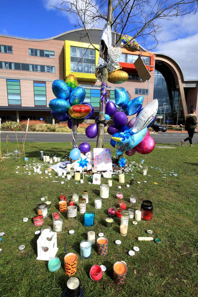 Balloons and candles outside Alder Hey Children’s Hospital  (John Stillwell/PA)