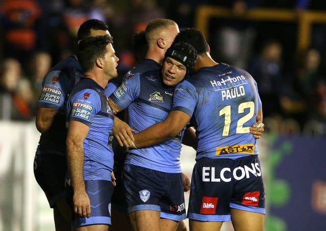 Jonny Lomax (centre) celebrates scoring St Helens' eighth try in the crushing 42-12 win over Castleford on Friday night
