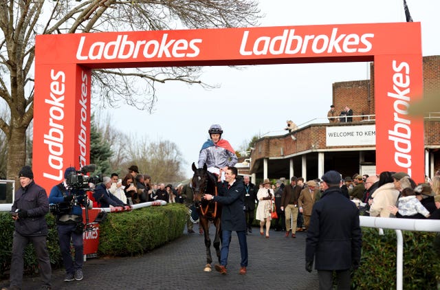 James Reveley returns  to the Kempton winner's enclosure draped in the French flag 