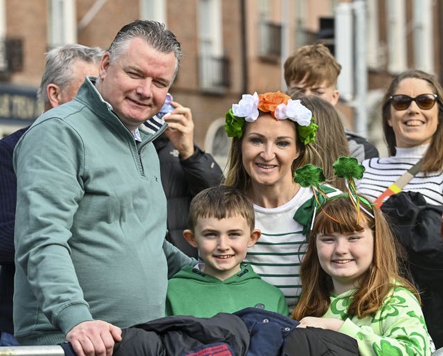 Derek, Eoin, Paula, and Emma Donnelly, from Dublin wait for the St Patrick’s Day Parade in Dublin.