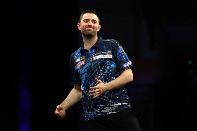 Luke Humphries clenches his fist as he turns to celebrate