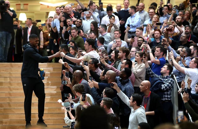Anthony Joshua greets fans as he arrives at the final press conference