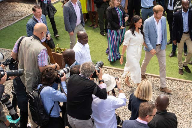 The media watch Harry and Meghan depart after a visit to the Tembisa township in Johannesburg