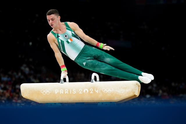 Rhys McClenaghan spins over the pommel horse during his qualifying routine in Paris