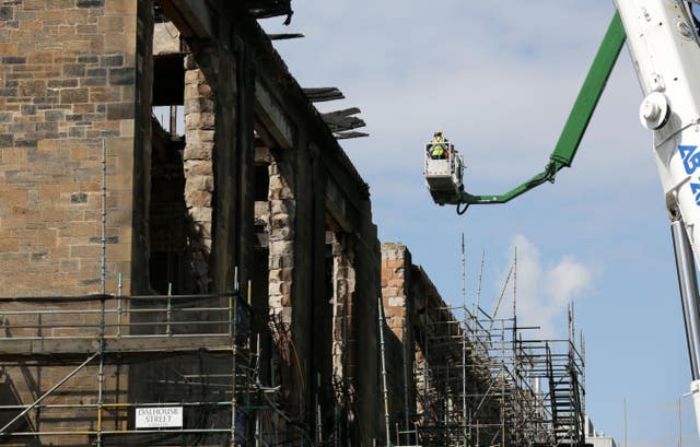 Workmen dismantle parts of the Mackintosh building