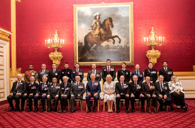 Members of the Victoria Cross and George Cross Association pose for a group photograph with Charles and Camilla (Richard Pohle/The Times via PA)