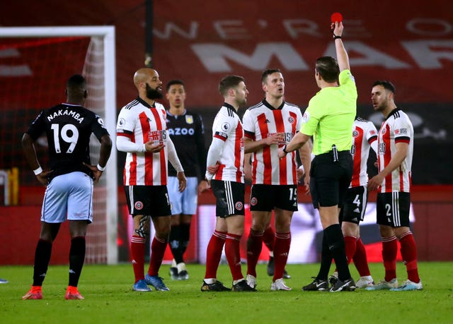 Sheffield United’s Phil Jagielka (centre right) sees his yellow card upgraded to a red card after referee Robert Jones consults the VAR