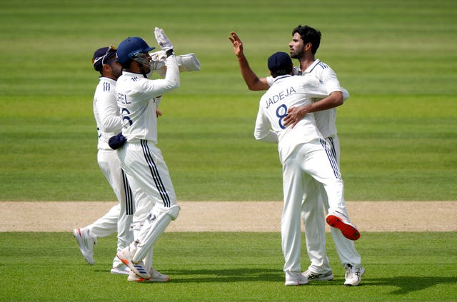 India’s Washington Sundar (right) celebrates with team-mates after taking the wicket of England’s Joe Root