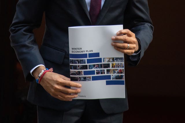 Chancellor Rishi Sunak holds a copy of his Winter Economy Plan