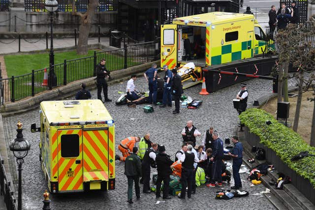 Emergency services attending Khalid Masood, top, and police officer Keith Palmer, bottom, outside the Palace of Westminster after Masood ploughed into pedestrians on Westminster Bridge