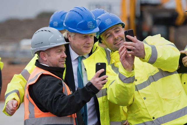 Boris Johnson posing for selfies with construction workers