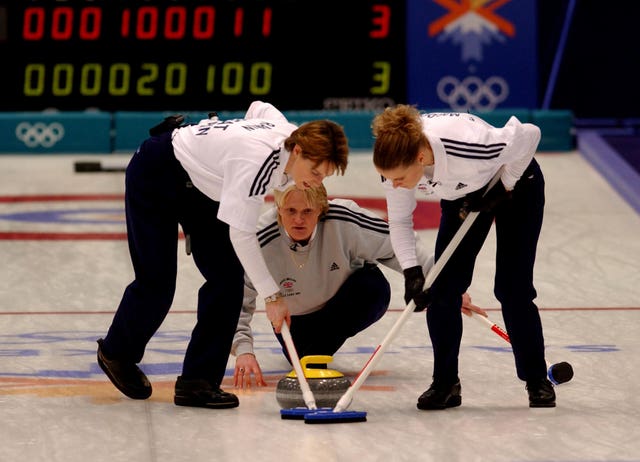 Great Britain sweep in front of the stone after skip Rhona Martin’s final decisive throw to win Olympic gold at the 2002 Winter Olympic Games