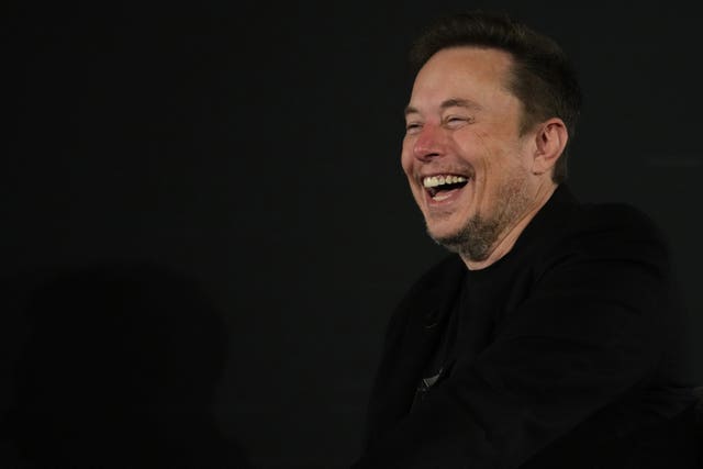 Elon Musk laughs during an ‘in-conversation’ event in London