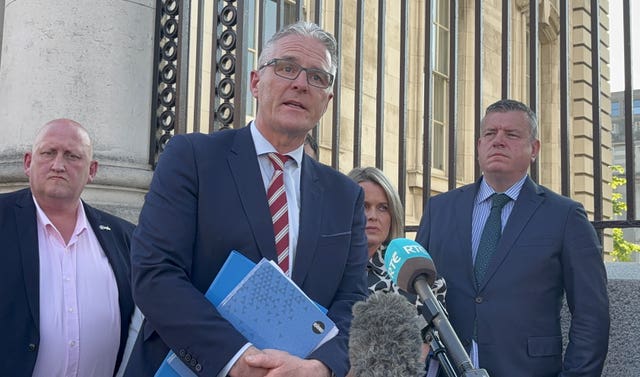 GAA president Jarlath Burns speaks to media in support of the family of Sean Brown following a meeting with Tanaiste Simon Harris at Government Buildings in Dublin