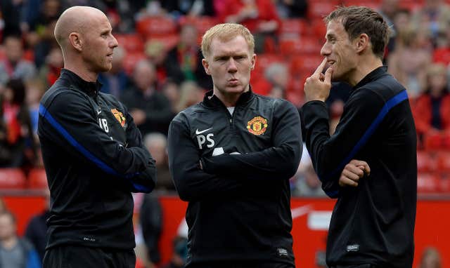 Scholes, centre, pictured during his stint as a United coach in 2014 
