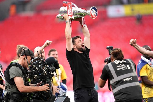 Russell Martin lifts the Championship play-off final trophy