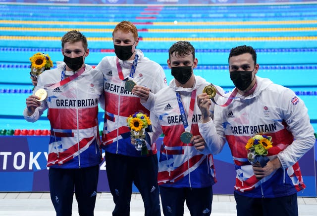 Duncan Scott, Tom Dean, Matthew Richards and James Guy celebrate gold in the men’s 4×200 freestyle relay in Tokyo