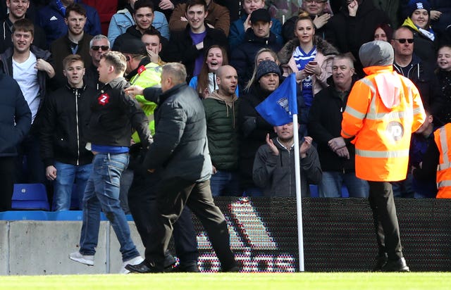 Paul Mitchell being escorted from the pitch after attacking Aston Villa’s Jack Grealish