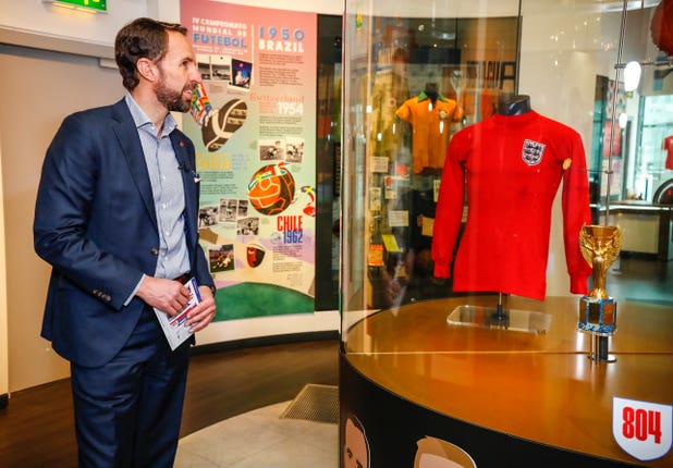 Gareth Southgate looking at an England shirt from the 1966 World Cup final