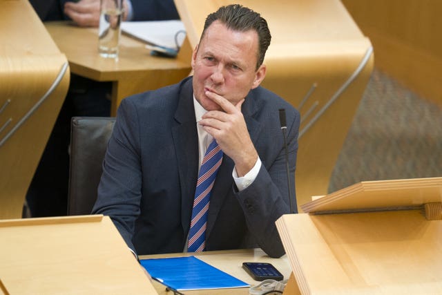 Russell Findlay seated in Holyrood