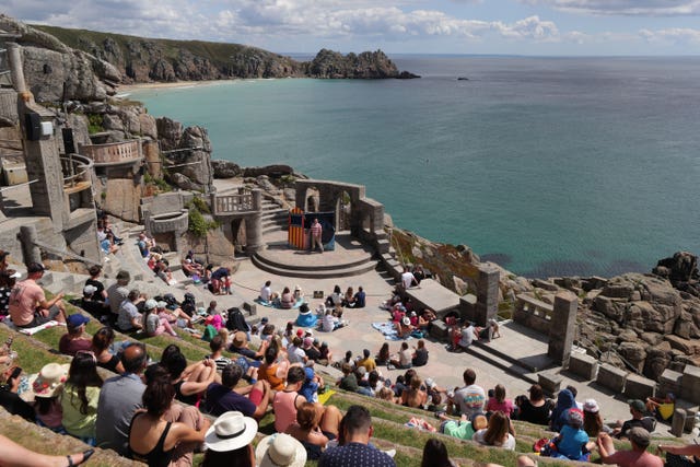 An audience enjoys the Sea Show performance at the Minack Theatre in Porthcurno near Lands End, on August 3