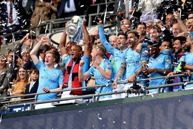 Vincent Kompany lifts the FA Cup after Manchester City complete a domestic treble with a 6-0 rout of Watford at Wembley