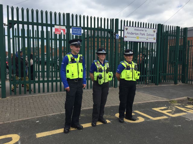 Police outside the school during demonstrations (Richard Vernalls/PA)