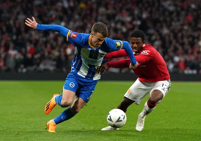 Tyrell Malacia challenges Brighton's Solly March in the FA Cup semi-final