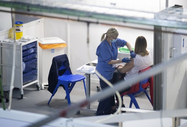 A nurse administers a coronavirus vaccine