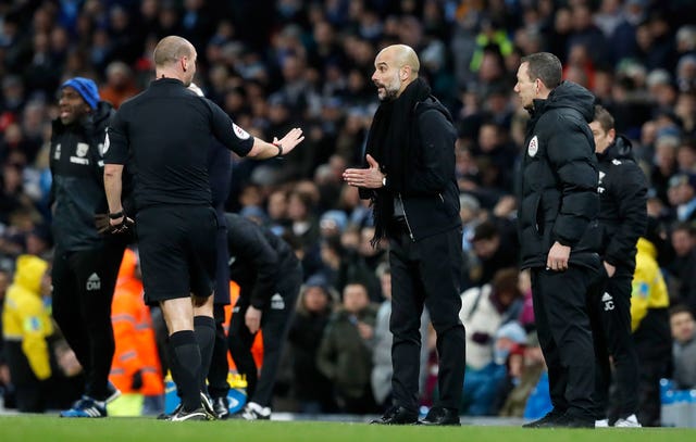Pep Guardiola, right, speaks to referee Bobby Madley after City's game with West Brom