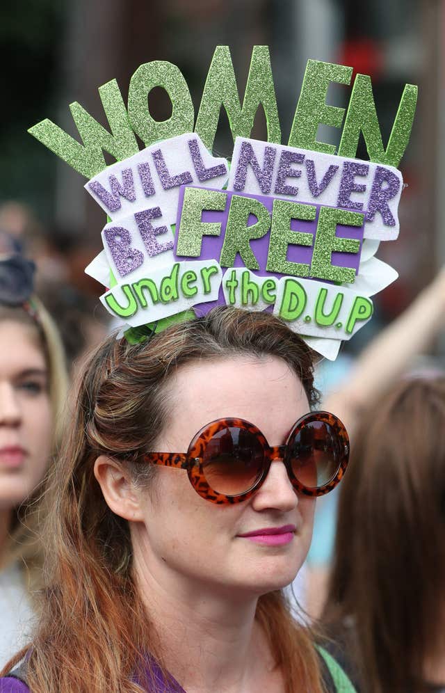 A woman wearing a hat critical of the DUP