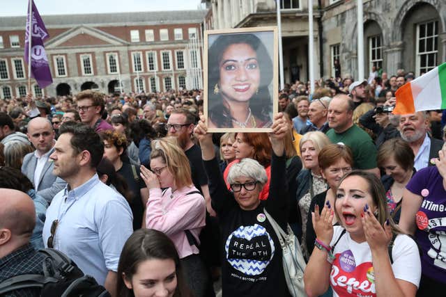 A supporter holds a photo of Savita Halappanavar (Niall Carson/PA)