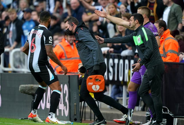 Newcastle United club doctor Paul Catterson (centre) was sent to attend to a fan who had taken ill in the stands 