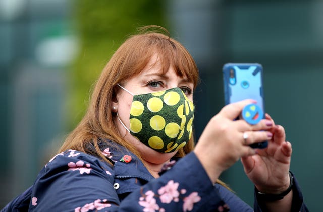 A fan wearing a face mask