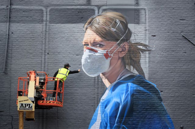 Artist Peter Barber working on a mural in Manchester city centre